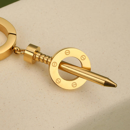 Aretes Largos En Acero Con Diseño De Tornillo Y Disco Hueco Dorado