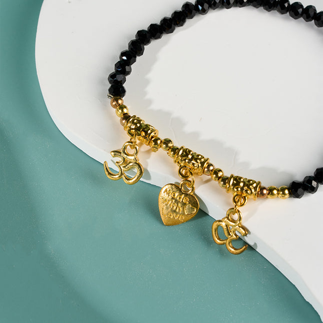 Pulsera De Cuentas Negras Con Tres Colgantes Dorados Estilo Moda